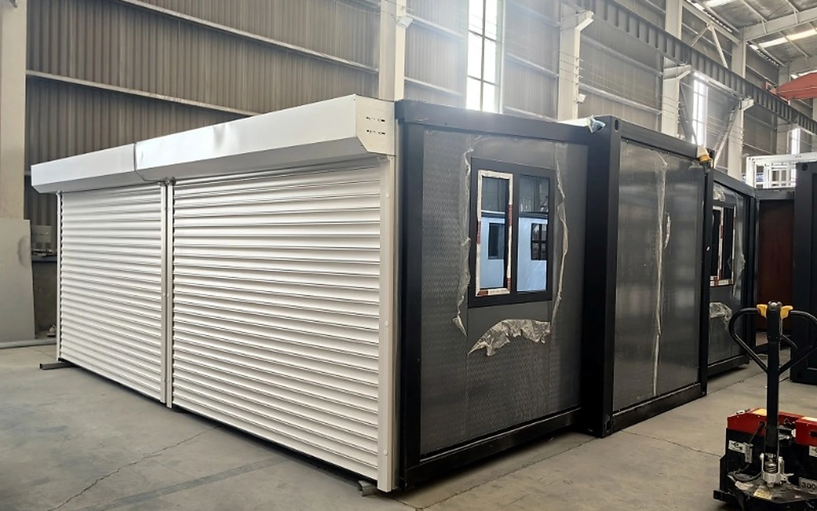 Two-bay folding garage assembled inside a factory