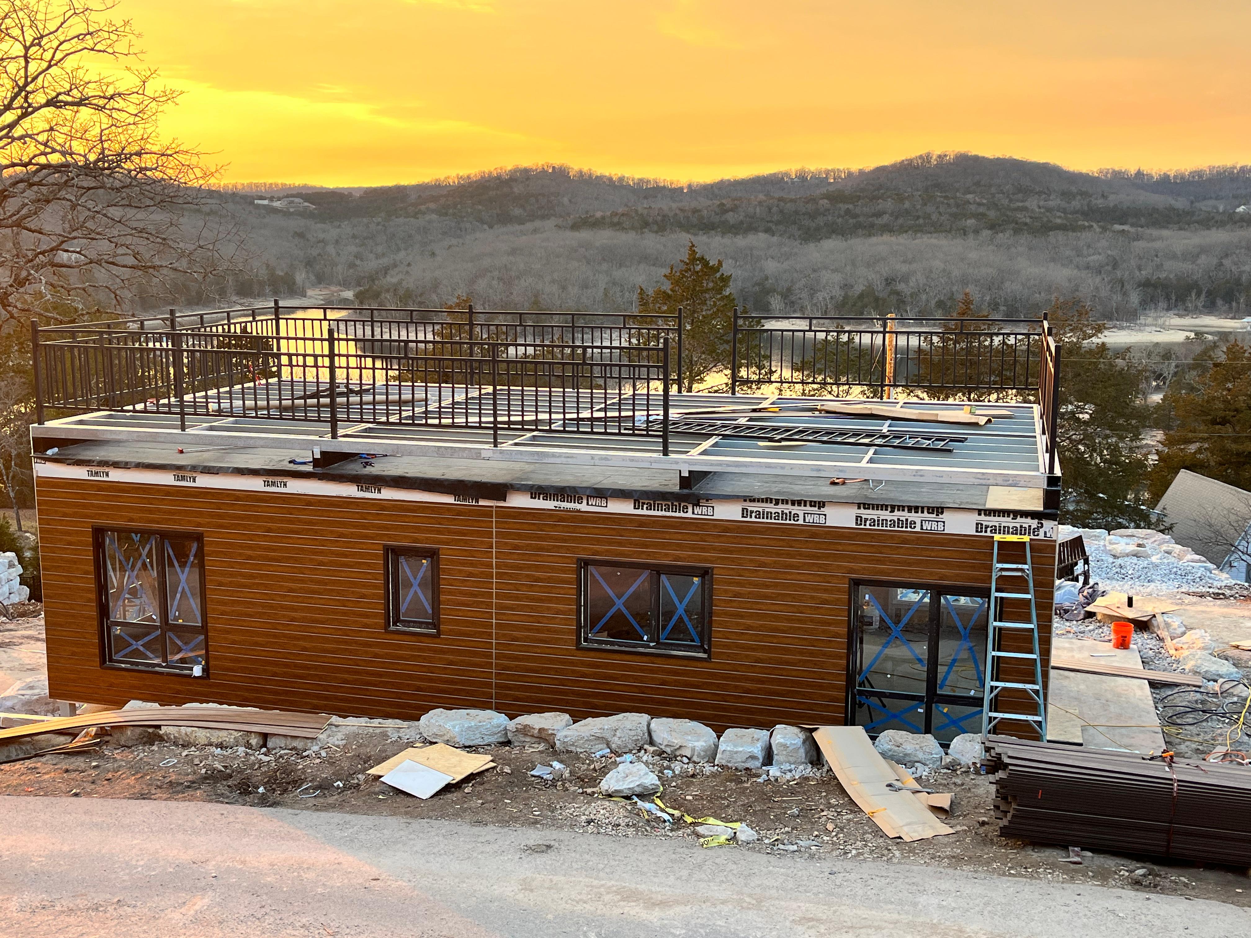 Cabin construction underway at a hillside project site in Missouri
