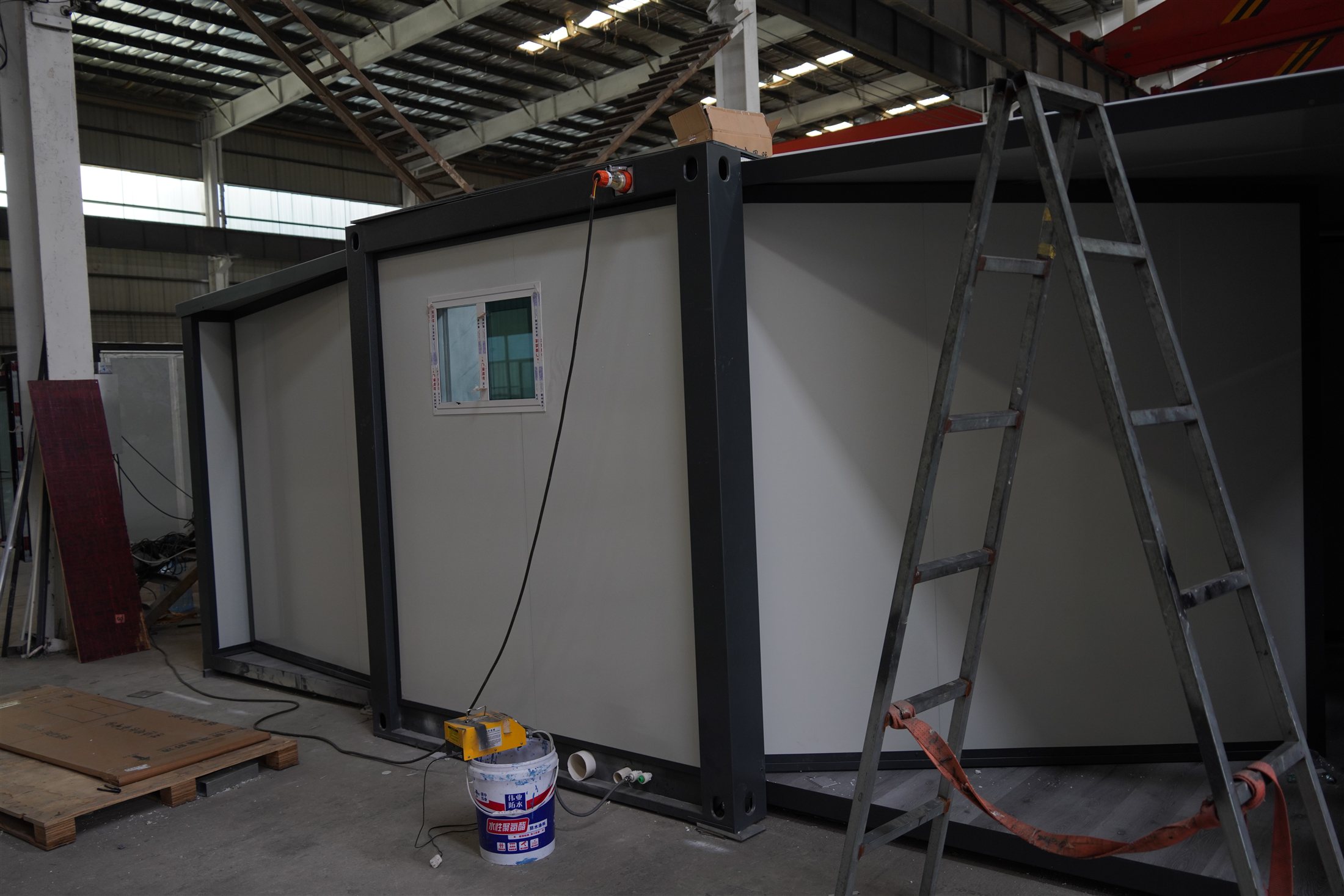 Modular service enclosure being assembled inside a production factory