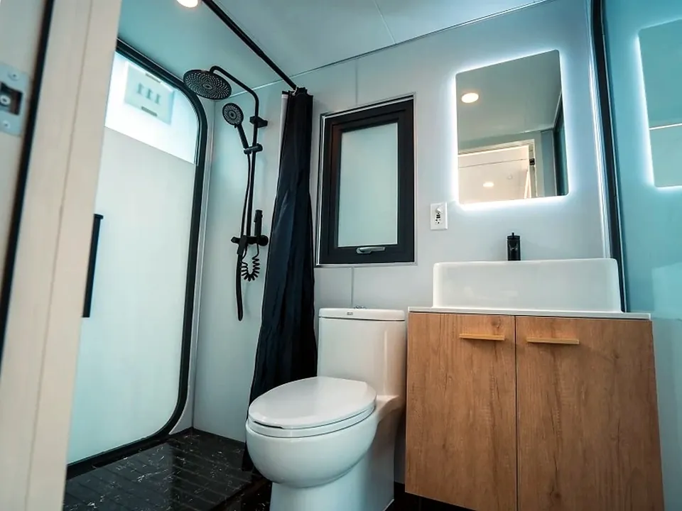 Finished modular cabin bathroom with shower, vanity and mirror