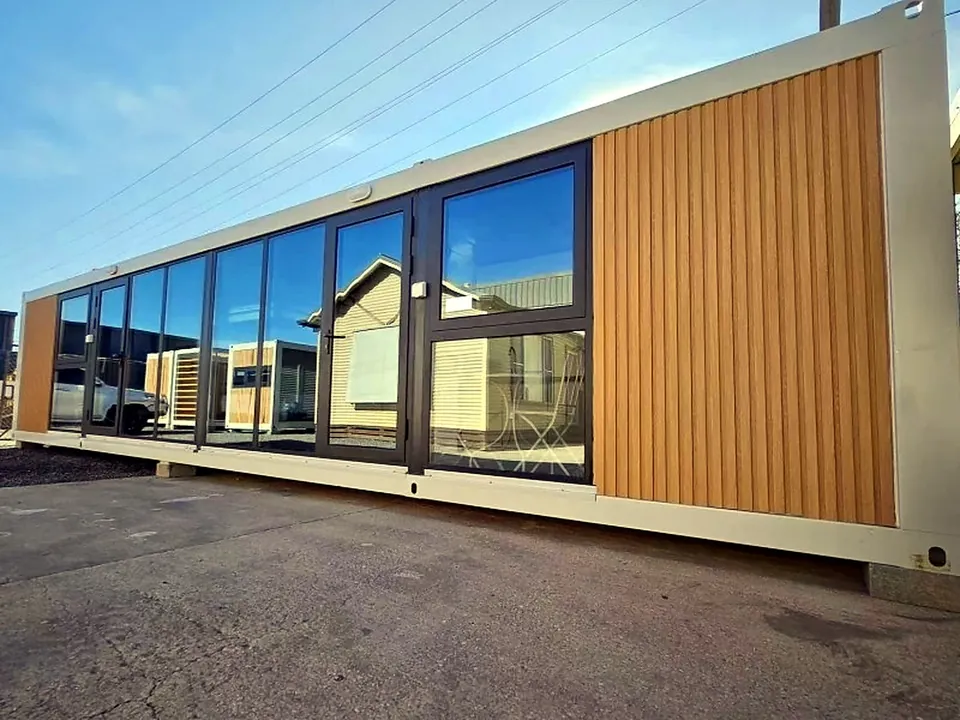 Modular cabin exterior with wood-look cladding and full-height glazing